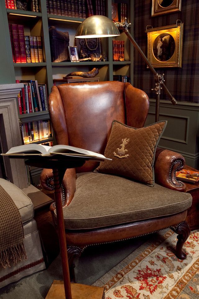 A cognac leather wingback chair beside a reading stand